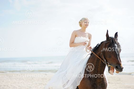 Bride on a horse by the sea