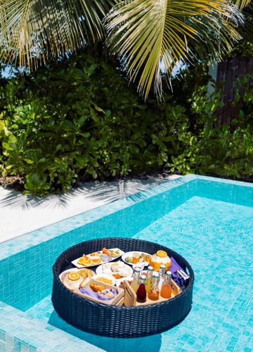 A floating breakfast tray with various dishes and drinks...