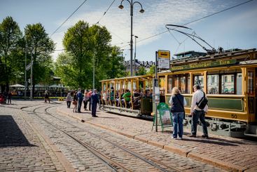 Pedestrians and tram on city street in Helsinki, Finland
