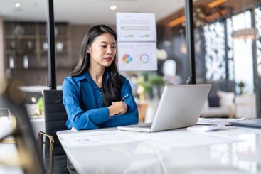 Beautiful Business Woman working by using laptop...