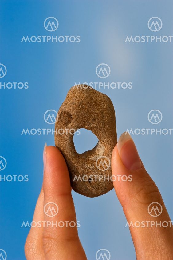 Hand with holey stone