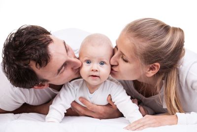 Closeup of young family with baby boy over white