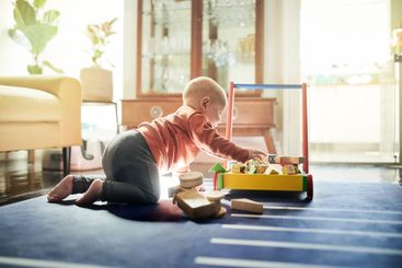 Childhood, learning and a baby with toys for playtime,...