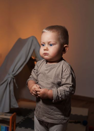 A Young Child in a Cozy Indoor Setting, Embracing the...