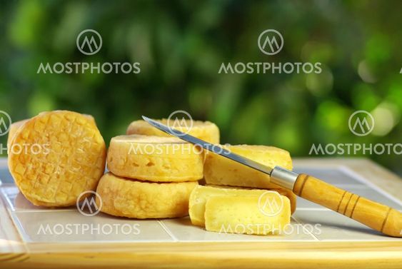 Yellow cheese of sheep at Portugal, and knife.