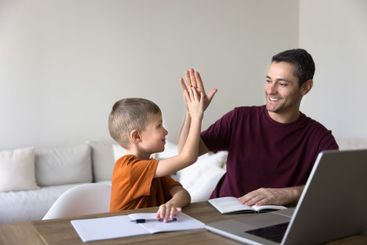 Dad encourages little school age son with great study...
