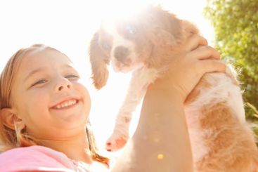 Smile, nature and portrait of kid with dog for bonding,...