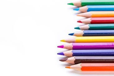 Colorful arrangement of sharpened colored pencils on...