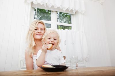 Child Eating With Mother