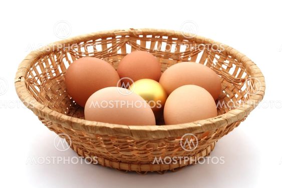 basket with usual chicken egg and golden egg on white background