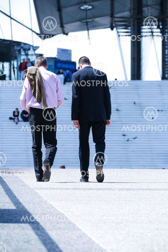 business men holding brief case and walking