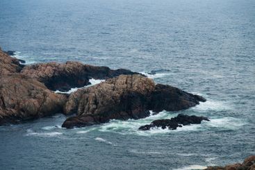 Rough rocky cliffs by the ocean.