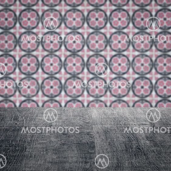 Wood table top and blur vintage ceramic tile pattern wall