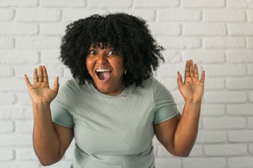 African American woman expressing pure joy with an...
