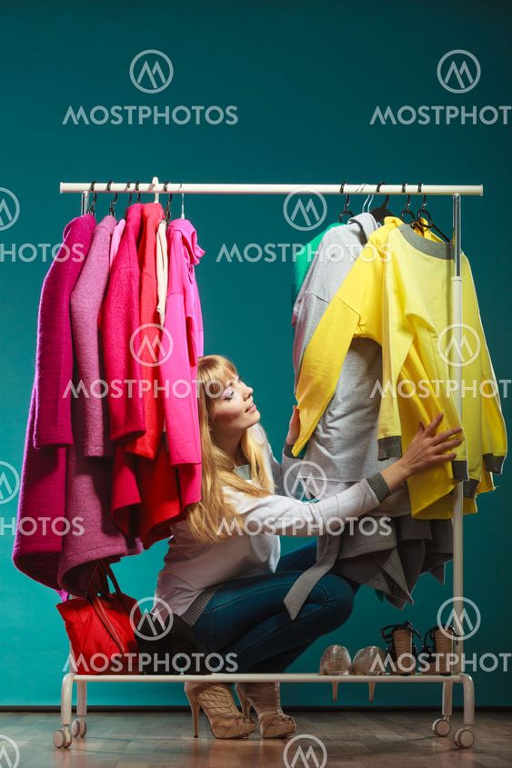 Woman choosing clothes to wear in mall or wardrobe