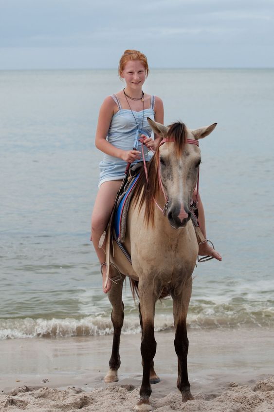 Girl rides on horse