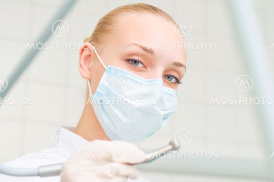 female dentists in protective mask