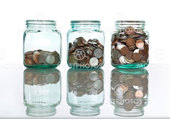 Glass jars with coins - savings concept