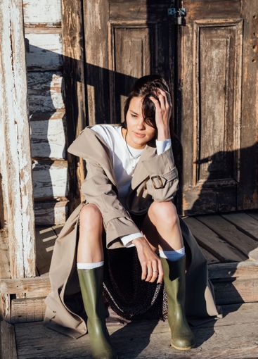 Beautiful fashionable brunette woman in gray coat on...