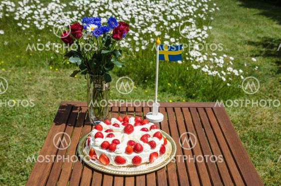 Table with strawberry cake and decorations