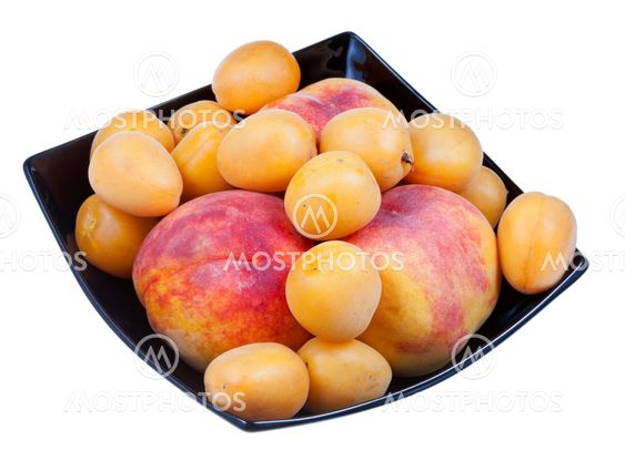 fresh peaches and apricots in black plate