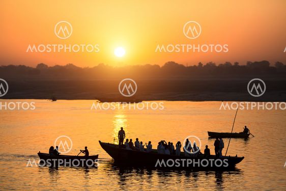 Dawn on the Ganges river, with the silhouettes of boats with pilgrims. Varanasi, India.