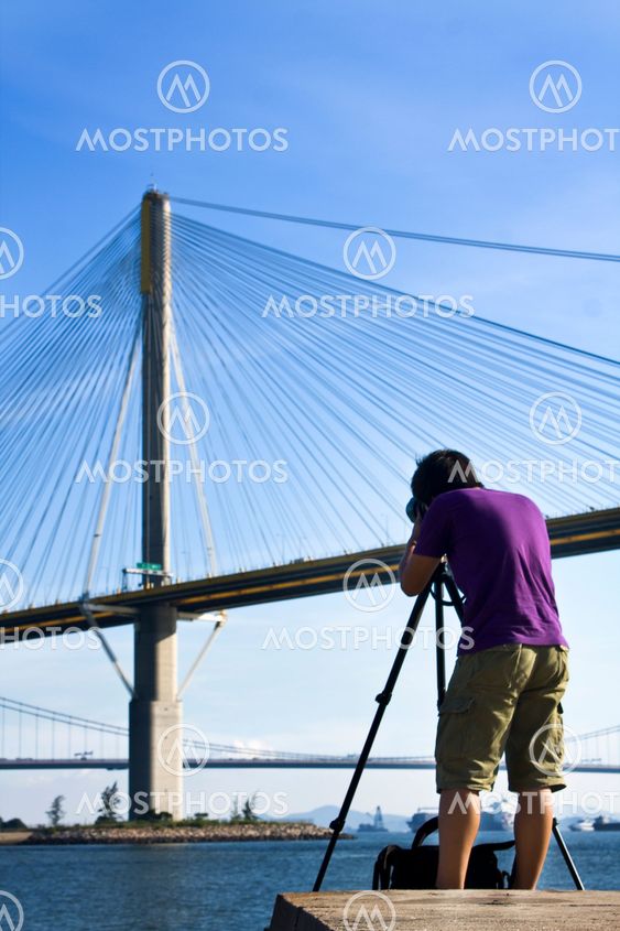 man take photo of the bridge