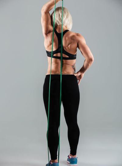 Full length of female athlete in sport wear stretching...