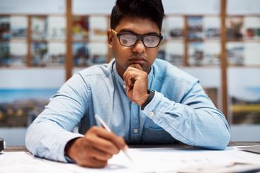 Man, thinking and writing in office for business, notes...