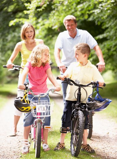 Family riding bikes in countryside