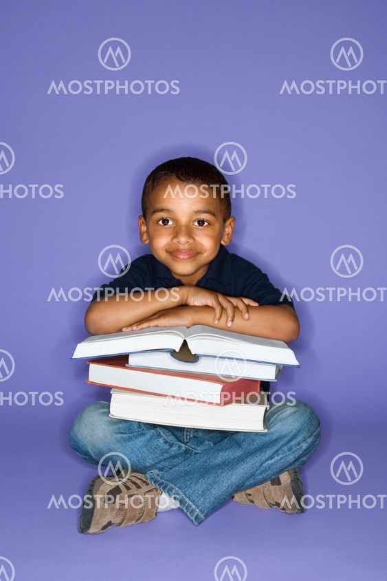 Boy sitting with books.
