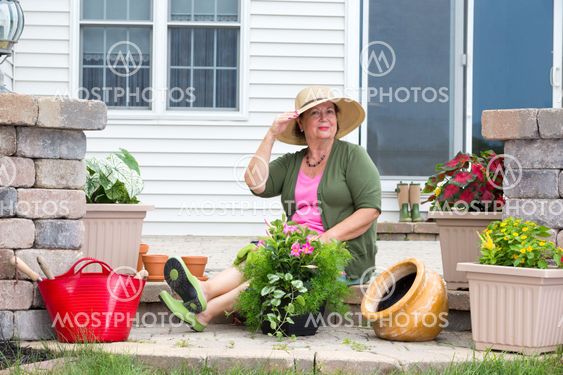 Elegant Grandma posing as she pots up plants