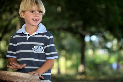 Little boy playing bongo in park