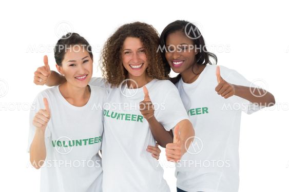 Attractive team of volunteers giving thumbs up at camera