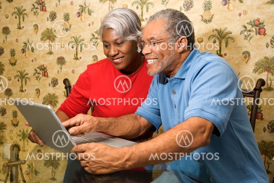 Mature couple with laptop.
