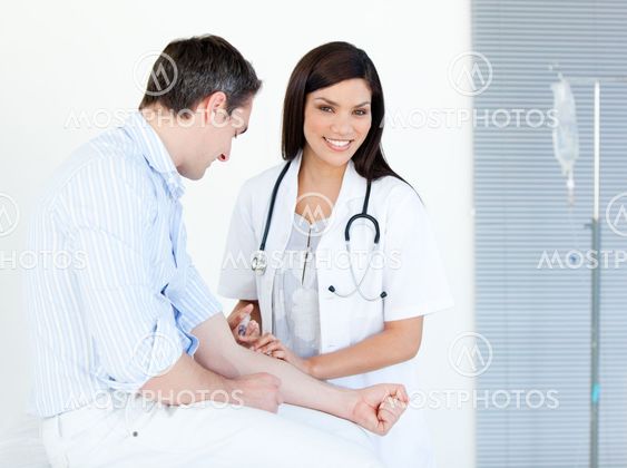 Smiling female doctor making injection to her patient