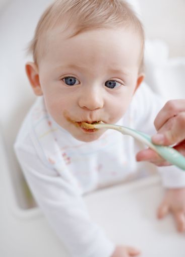 Baby nutrition, parent and hands feeding in home, hungry...