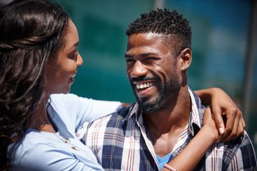Talking, black couple and laughing together outdoor with...