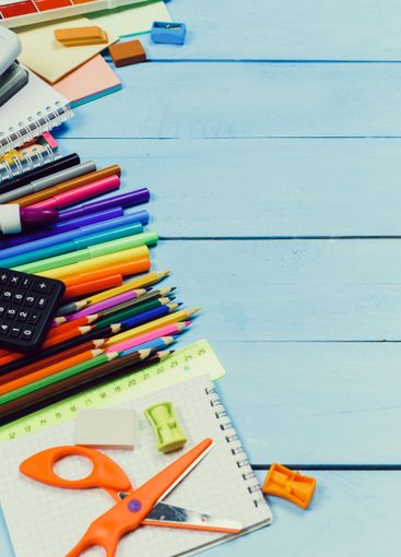 Colorful collection of school supplies arranged on a...