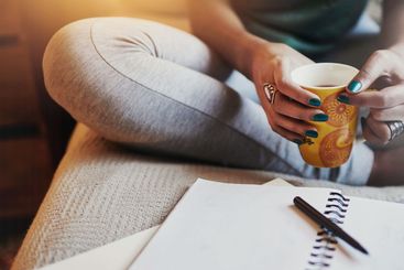 Notes, planning and woman in home office with coffee,...