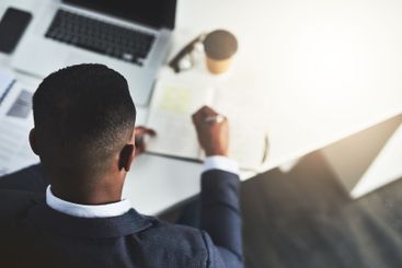 Business, man and writing in notebook in office for...