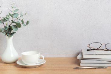 Eucalyptus branches, coffee cup, books and eyeglasses...