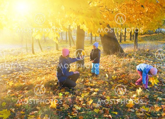 Family in autumn maple park