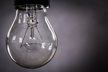 Close-up of electrical bulb on black background