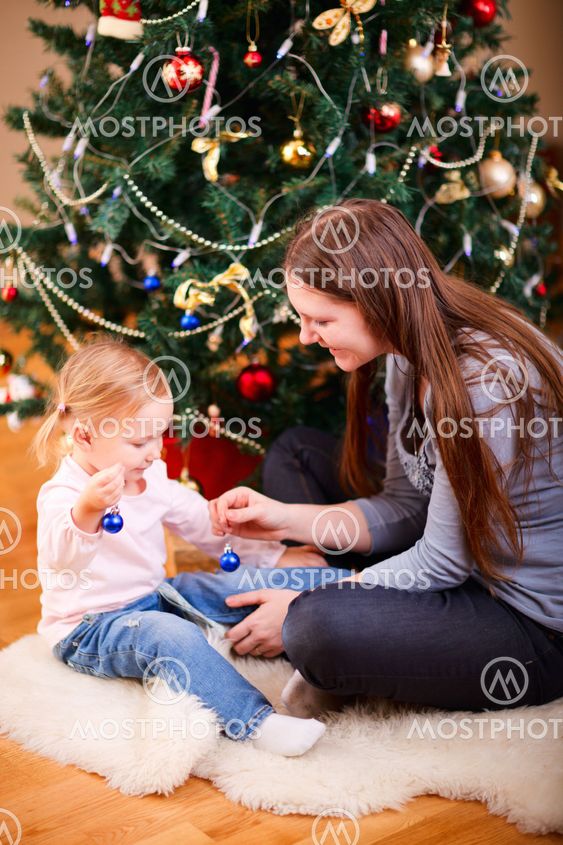 Mother and daughter near Christmas tree