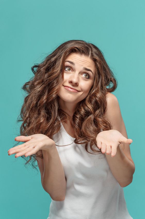 Frustrated young woman posing on blue