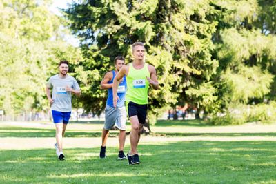 happy young sportsmen racing wit badge numbers