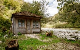 Old wooden house near the mountain river.