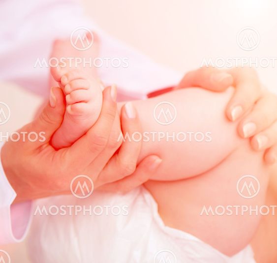 mother massaging baby