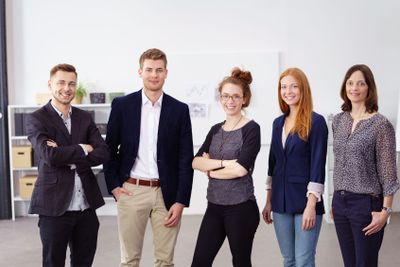 Group of five people standing beside each other